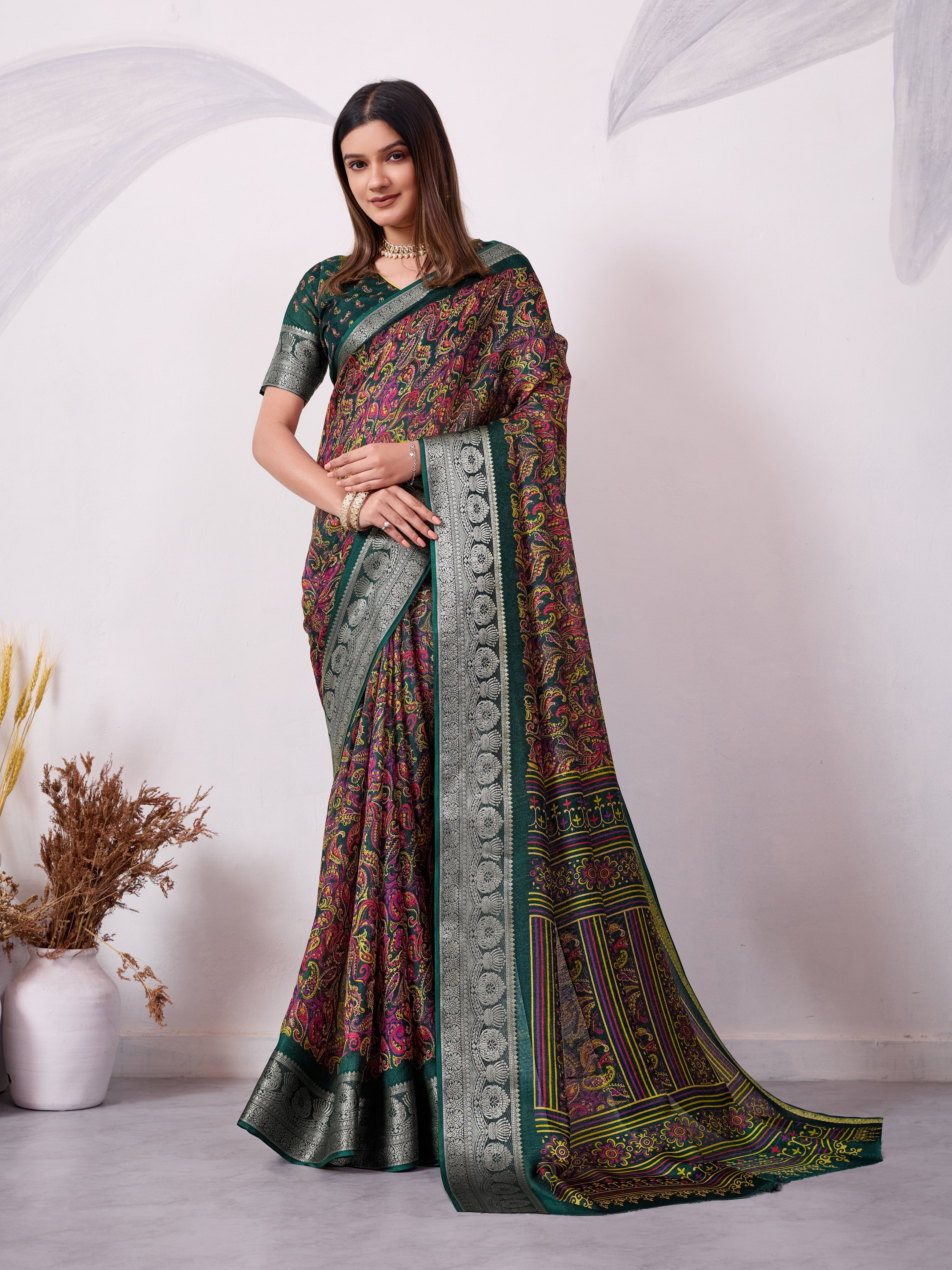 Green ethnic print saree with silver zari border and traditional motifs