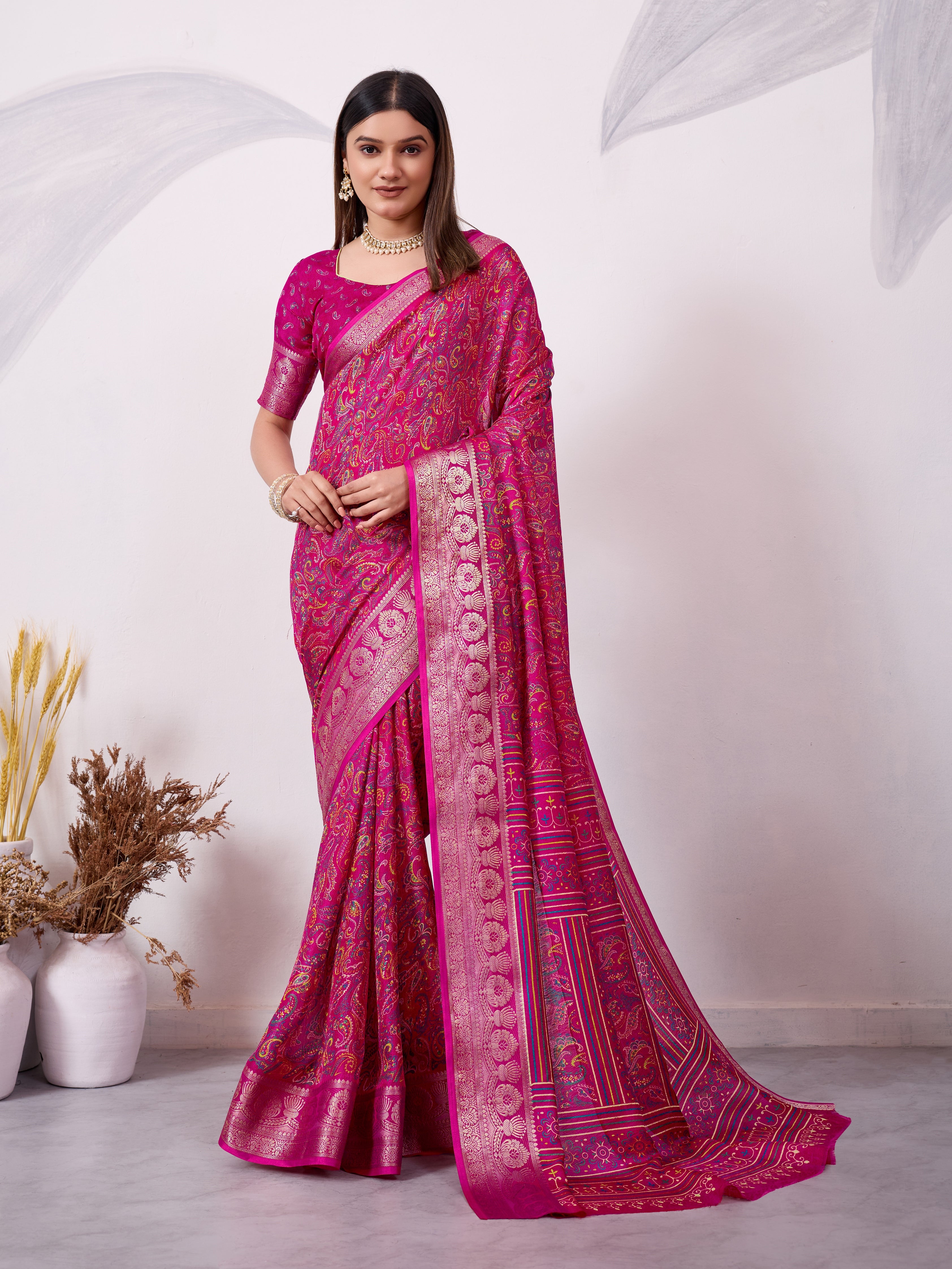 Pink ethnic print saree with silver zari border and traditional motifs