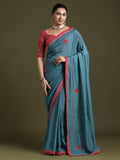 Elegant teal blue silk saree with red embroidered border and ethnic motifs
