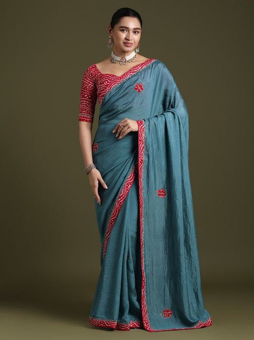 Elegant teal blue silk saree with red embroidered border and ethnic motifs