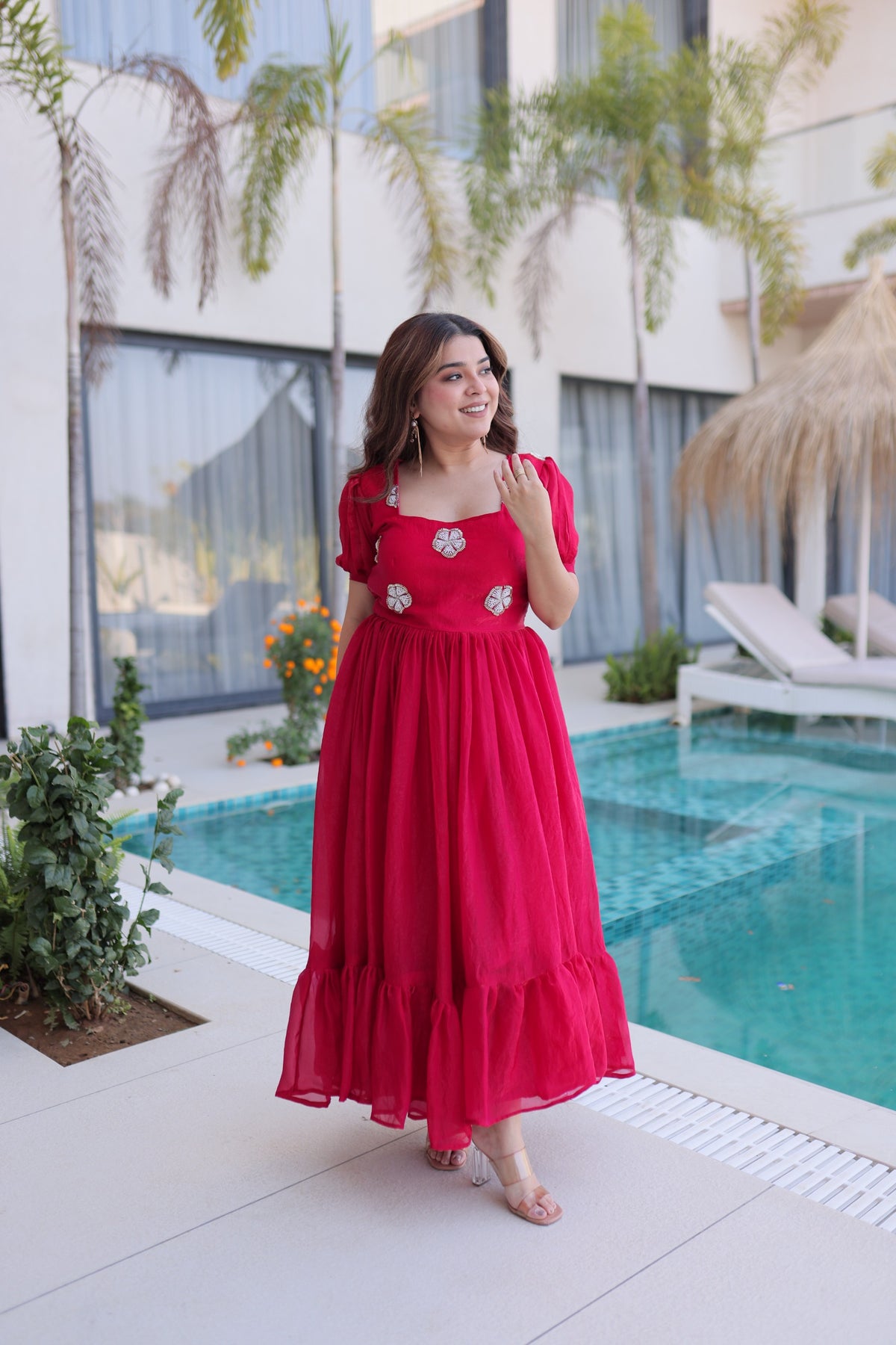 Women’s red maxi dress with puff sleeves and embroidered motifs, perfect for festive and vacation wear